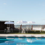 Wedding pool area with white umbrellas and Sunshine Coast Hinterland views at Maleny Country Estate