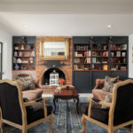 Estate House living room with brick fireplace and built-in bookshelves at Maleny Country Estate, Sunshine Coast Hinterland